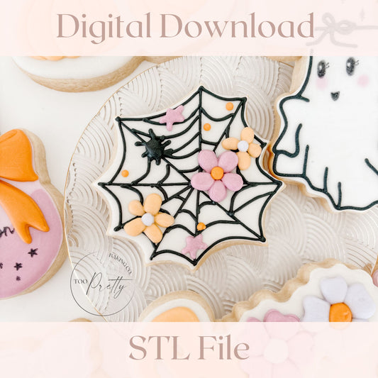Decorative cookies with spider web, flowers, and other designs on a white background.