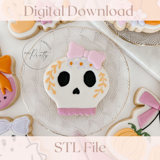 decorative sugar cookie with sugar skull with a bow and floral details.